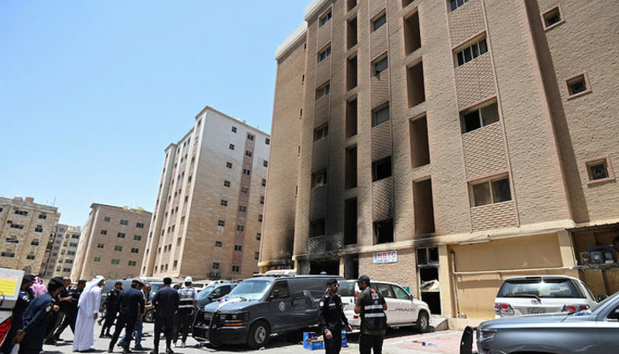 Police authorities inspect the burnt building housing workers in the city of Mangaf in Kuwait’s southern Ahmadi Governorate on June 12, 2024. — Reuters