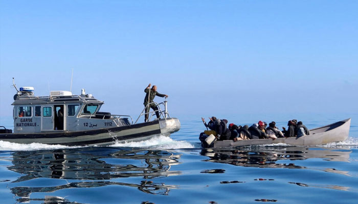 In this photo taken on April 27, 2023, Tunisian coast guard personnel try to stop migrants off the coast off Sfax during an attempt to cross the Mediterranean Sea to Italy. — Reuters