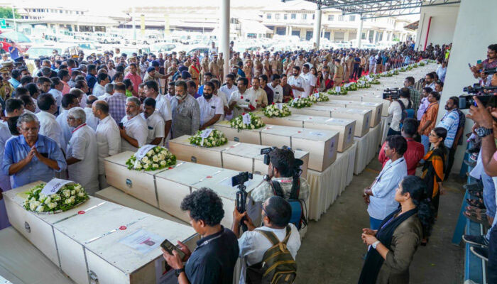 Relatives mourn near the deceased after the coffins arrival on an Indian Air Force plane from Kuwait at the Cochin International Airport on Friday. — AFP