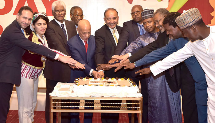 Federal Minister for Petroleum Musadik Masood Malik, Dean of the African group and Ambassador of Morocco Mohamed Karmoune, and heads of missions of the African countries cutting cake to celebrate the Africa Day at a local hotel on June 15, 2024. — INP