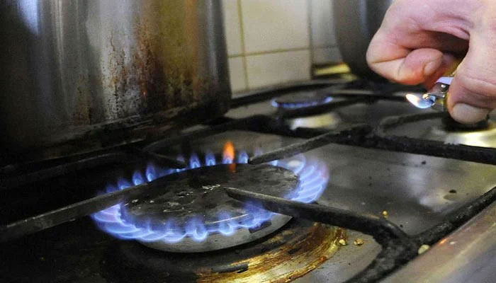 A representational image of a person lighting a stove. — AFP/File