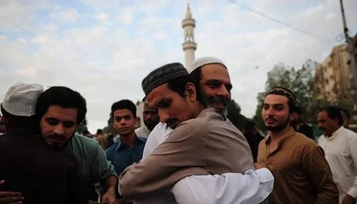 A representational image showing people embracing each other after Eid prayers. — AFP/File