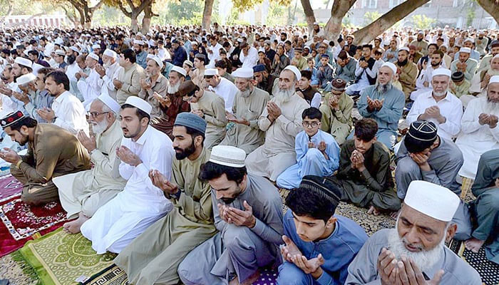 People offering dua after Eid prayers in Peshawar on April 22, 2023. — APP