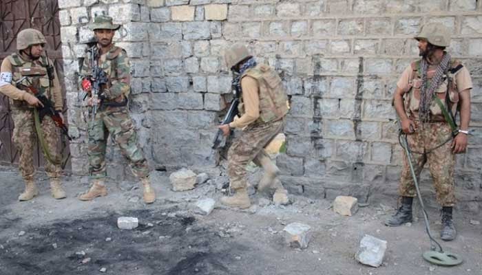 A representational image showing security personnel taking positions during an operation at an undisclosed location. — ISPR/File