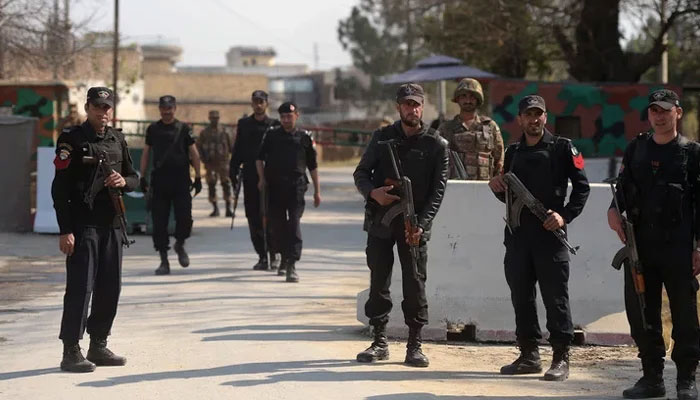 Soldiers and policemen stand guard outside the Haripur central jail in Mardan. — AFP/File