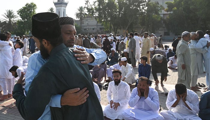 Muslims greet each other after offering Eid ul Adha prayers at the Eidgah ground in Rawalpindi on June 17, 2024. — AFP