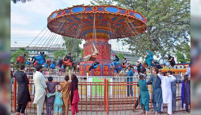 Youngsters enjoys swing in evening hours at Allama Iqbal Park on the 2nd day of Eid ul Azha in Rawalpindi on June 19, 2024. — Online