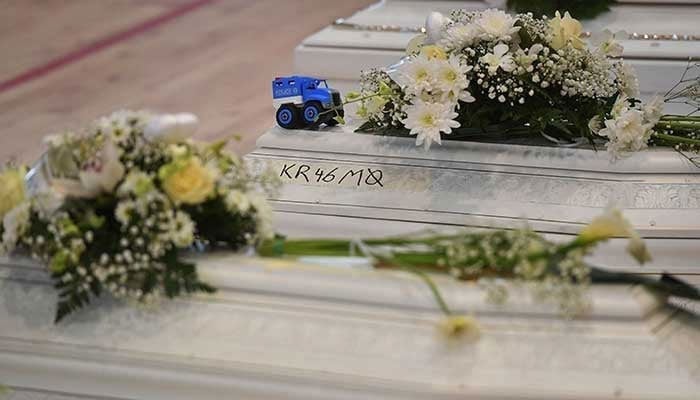 A representational image showing flowers placed on coffins at a funeral. — AFP/File