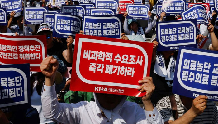 Doctors strike and shout slogans during a rally to protest against government plans to increase medical school admissions and healthcare reform in Seoul. — Reuters/File