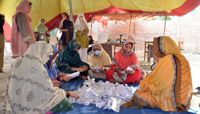 The staff of the Election Commission of Pakistan counting votes in a polling station after the local body elections in District Dera Allah Yar. — Online/File