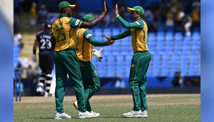 South Africa´s Kagiso Rabada celebrates winning the match with Keshav Maharaj during the ICC men´s Twenty20 World Cup 2024 Super Eight cricket match between the United States and South Africa at Sir Vivian Richards Stadium in North Sound, Antigua and Barbuda on June 19, 2024. — AFP