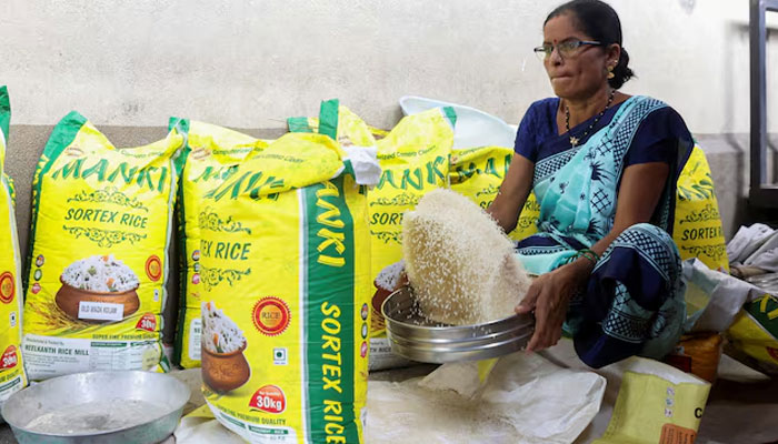 A woman cleans rice grains at a wholesale market in Navi Mumbai, India August 4, 2023. — REUTERS