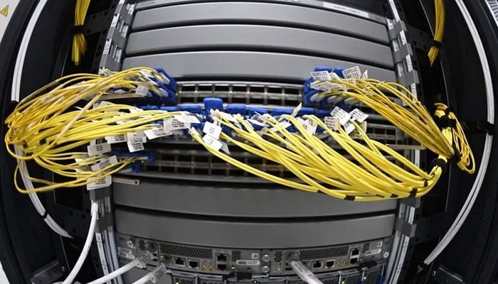 Optical fibers on network infrastructure are seen at the data center of French mobile communications company SFR in Cesson-Sevigne, in the suburbs of Rennes, western France, Dec. 14, 2020. — AFP