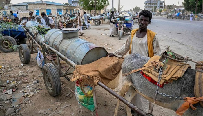 People queue to refill donkey-drawn water tanks during a water crisis in Port Sudan in the Red Sea State of war-torn Sudan on Apr. 9, 2024. — AFP/File