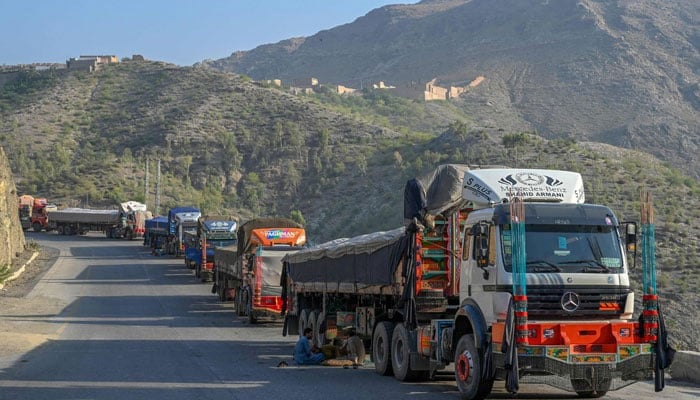 Trucks are seen parked along a road near the Pakistan-Afghanistan border in Torkham on September 11, 2023.  — AFP