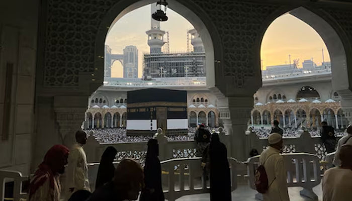 Police officers stand guard as Muslim pilgrims circle the Kaaba as they perform Tawaf at the Grand Mosque, during the annual haj pilgrimage, in Makkah, Saudi Arabia, June 18, 2024. — Reuters