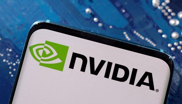 A smartphone with a displayed NVIDIA logo is placed on a computer motherboard in this illustration taken March 6, 2023. — REUTERS