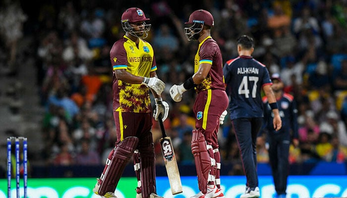 West Indies Johnson Charles (L) and Shai Hope (R) celebrate a 50 runs partnership during the ICC men’s Twenty20 World Cup 2024 Super Eight cricket match between USA and West Indies at Kensington Oval in Bridgetown, Barbados on June 21, 2024. — AFP