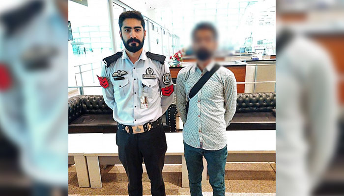 An FIA official pictured with the passenger allegedly travelling via fake documents at Islamabad airport on June 22, 2024. — Facebook/Federal Investigation Agency - FIA