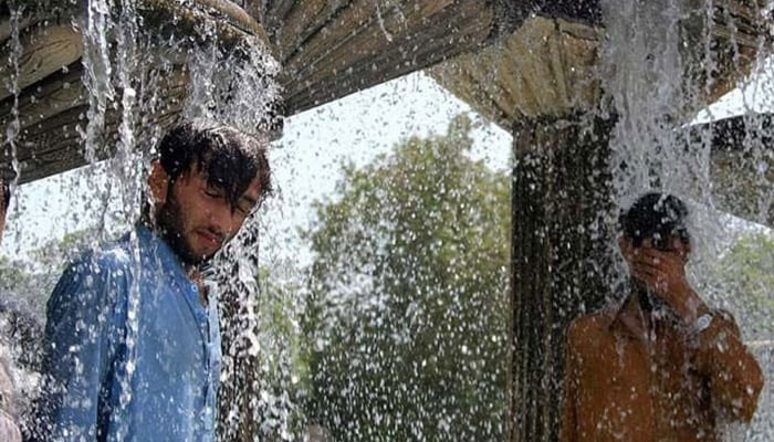 People cool off during a hot summer day. — AFP/File