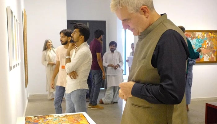 Visitors examine art pieces on the walls during an exhibition Titled ‘Texture of Time’ by Dr Iram Zia Raja organised by Canvas Gallery, image released on June 11, 2024. — X/@CanvasGallery