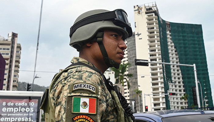 Mexican army infantry soldiers aboard military trucks patrol the streets in the tourist port of Acapulco, Guerrero state, Mexico during a security operation in the face of a growing wave of violence recently. — AFP