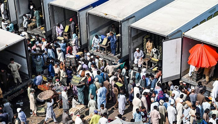 Traders, workers, and customers gather at a wholesale fruit market in Lahore on October 16, 2022, which also marks the ‘World Food Day.’ — AFP/File