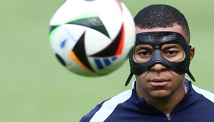 Kylian Mbappe sports a mask in training on Sunday. — AFP/file