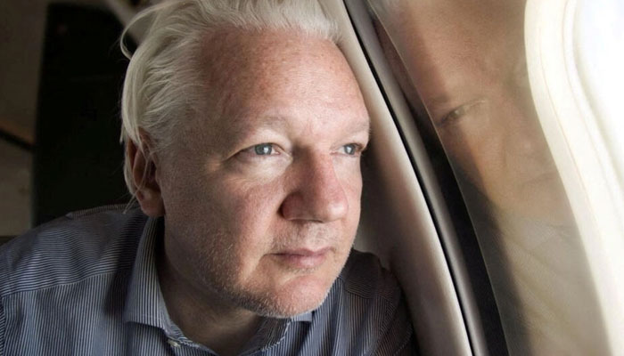 WikiLeaks founder Julian Assange looks out the window of a plane as he approaches Bangkok airport for a stopover, as published by Wikileaks on X, in this image posted on social media on June 25, 2024. — Reuters