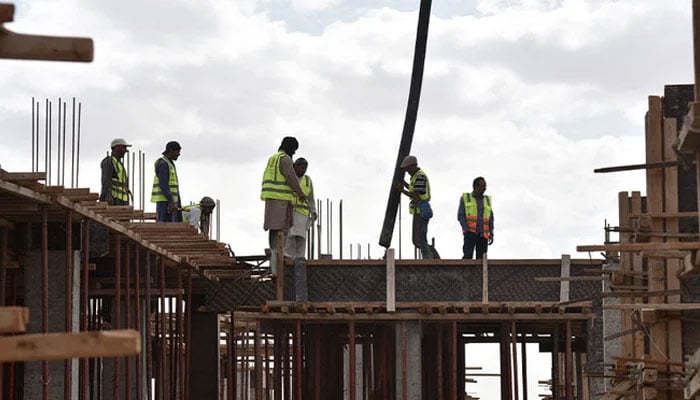 In this representative photo, workers can be seen at a construction site. — AFP/File