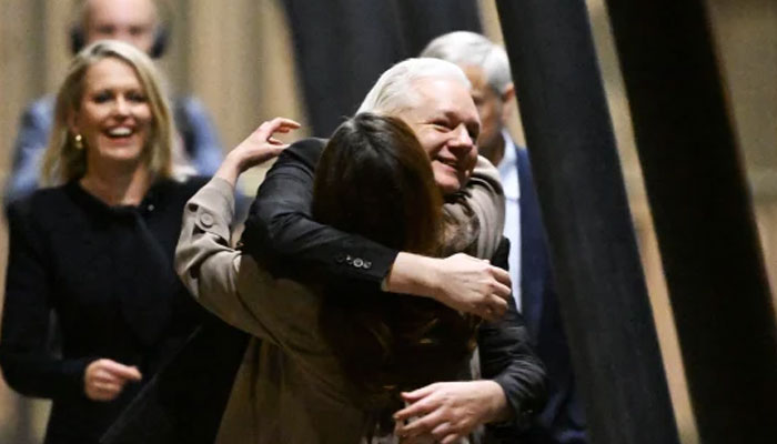 WikiLeaks founder Julian Assange hugging his wife, Stella Assange, after arriving in Canberra on June 26, 2024. — AFP