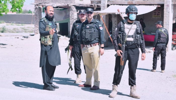 KP police personnel stand guard on the road on May 6, 2024. — Facebook/Bannu Police