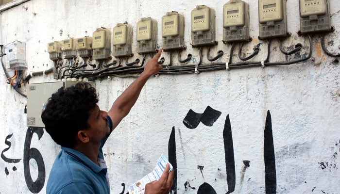 A man checking an electricity metre reading in Karachi on Friday, June 7, 2024. — PPI