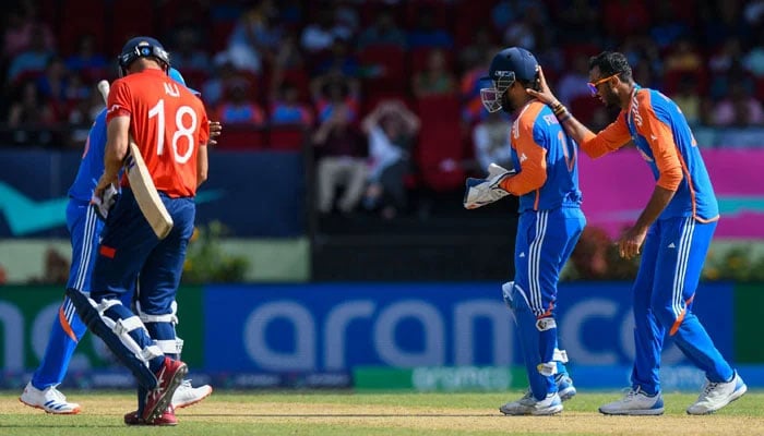 Axar Patel (R) and Rishabh Pant (2nd R) of India celebrate the dismissal of Moeen Ali (L) of England during the ICC men´s Twenty20 World Cup 2024 semi-final cricket match between India and England at Providence Stadium in Georgetown, Guyana, on June 27, 2024. — AFP