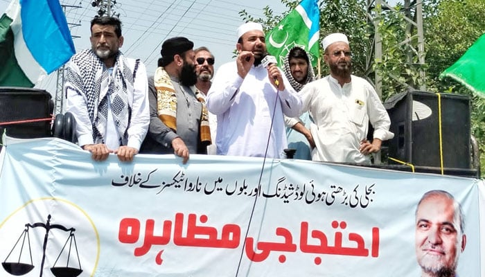Jamaat-e-Islami (JI) KP general secretary Abdul Wasi addressing the protest rally outside the headquarters of the Peshawar Electric Supply Company against the hours-long power outages on June 28, 2024. — Facebook/JIKPOfficial