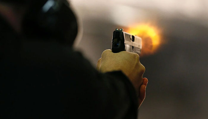 Representational image of a person firing a hand gun. — APP/File