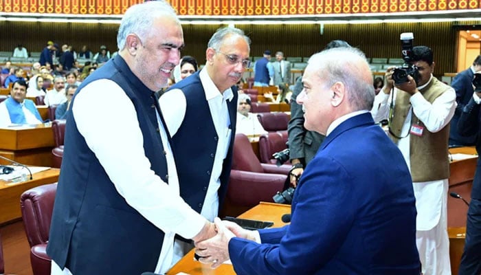 Prime Minister Shehbaz Sharif (right) shakes hands with PTI leader Asad Qaiser at National Assembly in Islamabad on June 26, 2024. — PM Office