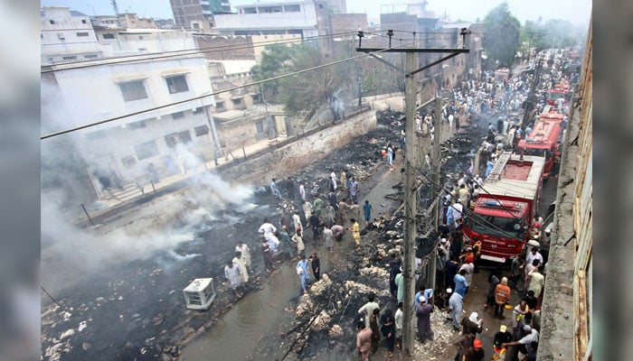 View of site after fire broke out incident at shops as fire brigade officials are busy in extinguishing fire and rescue operation, located on Nothia area of Peshawar on June 29, 2024. — PPI