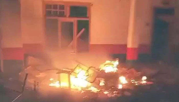 Protesters set fire to the Madyan Police Station and the vehicles parked there on June 20, 2024. — Geo News Screengrab
