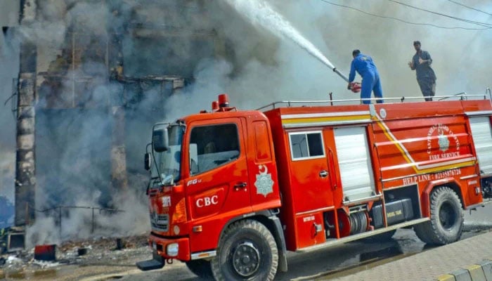 This representational image shows fire brigade officials extinguish a fire. — INP/File
