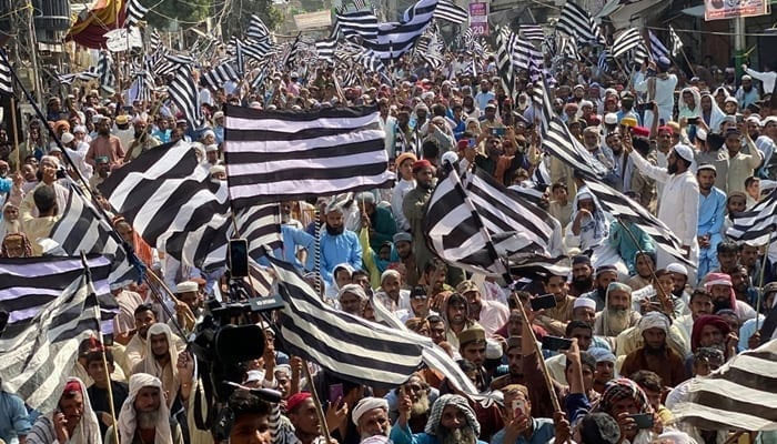 JUI-F supporters hold flags during a party rally in this image released on October 26, 2023. — Facebook/Jamiat Ulama-e-Islam Pakistan