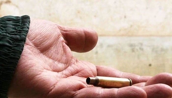 A representational image shows a person holding a bullet shell. — AFP/File