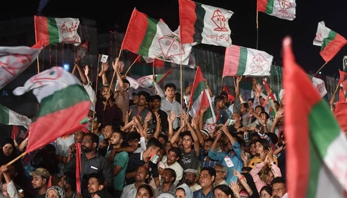 Supporters of Pakistani political Muttahida Qaumi Movement-Pakistan (MQM-P) party wave party flags. — AFP/File