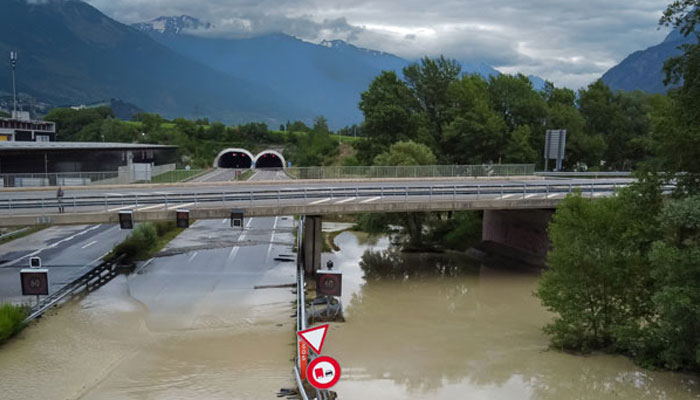 An aerial picture taken on June 30, 2024 shows the A9 motorway A9 partially flooded near Sierre, western Switzerland. — AFP