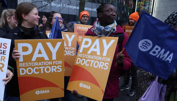 Junior doctors hold placards as they stand on a picket line outside the Royal University Hospital during a national strike over pay and conditions, in Liverpool, Britain, January 3, 2024. — Reuters