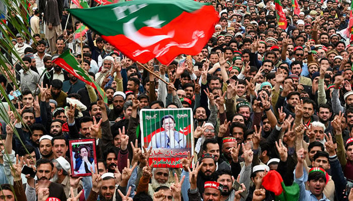 Pakistan Tehreek-e-Insaf (PTI) supporters hold portraits of partys Imran Khan during a protest against the alleged skewing in general elections, in Peshawar on March 10, 2024. — AFP