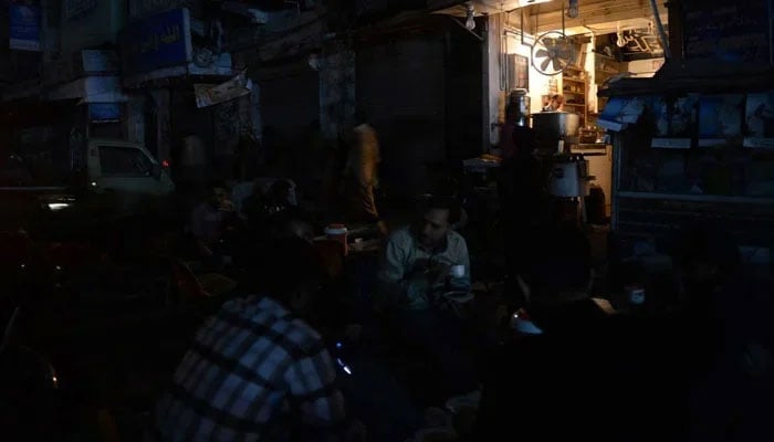 Representational image of an area in Pakistan where people are seen sitting outside at a cafe amid loadshedding. — AFP/File