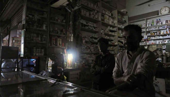 Representational image of a medical store with the owner sitting in the dark because of load-shedding. — APP/File