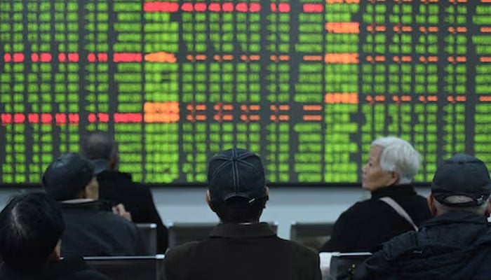 Investors sit in front of a board showing stock information at a brokerage house on the first day of trade in China since the Lunar New Year, in Hangzhou, Zhejiang province, China February 3, 2020. — Reuters
