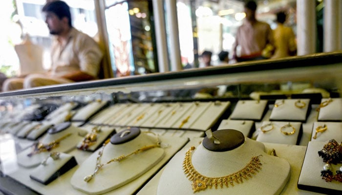 A jeweller waits for a customers at a shop in Karachi on June 26, 2024. — AFP